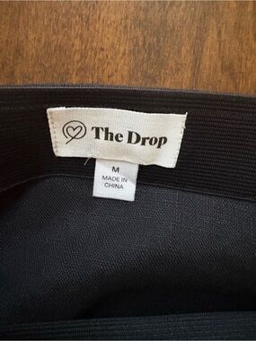 The Drop Black Top with Logo Tag